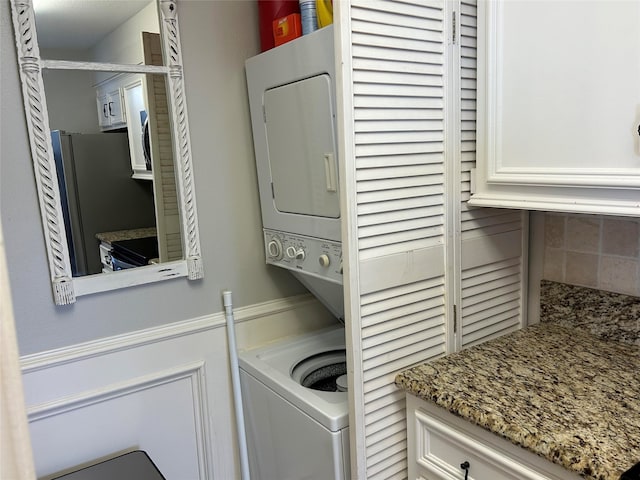 laundry area featuring stacked washing maching and dryer