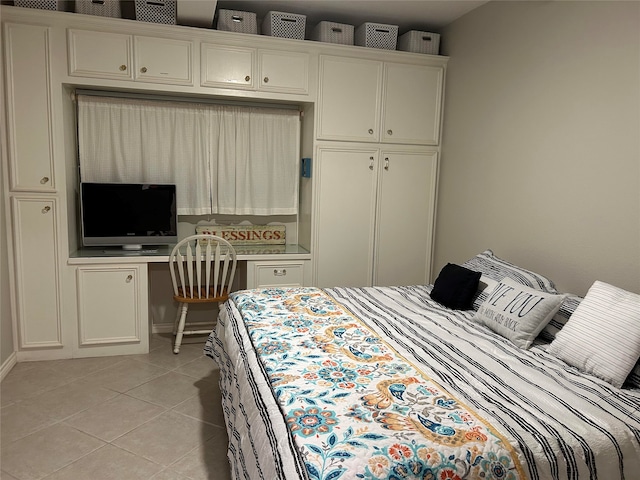 tiled bedroom with a closet