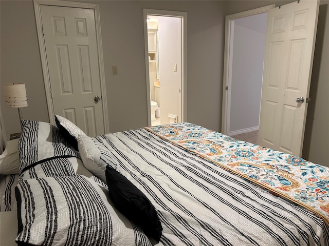 bedroom with carpet flooring and ensuite bath