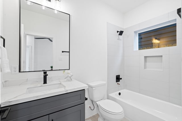 full bathroom with tiled shower / bath combo, toilet, and vanity