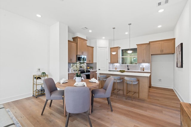 dining area with light hardwood / wood-style floors