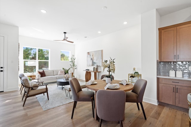 dining space featuring ceiling fan and light wood-type flooring