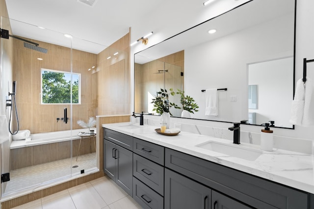 bathroom featuring tile patterned flooring, vanity, and shower with separate bathtub