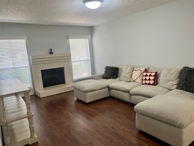 living room with dark wood-type flooring and a textured ceiling