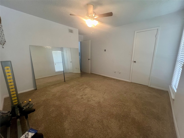 unfurnished bedroom featuring light colored carpet, a closet, and ceiling fan