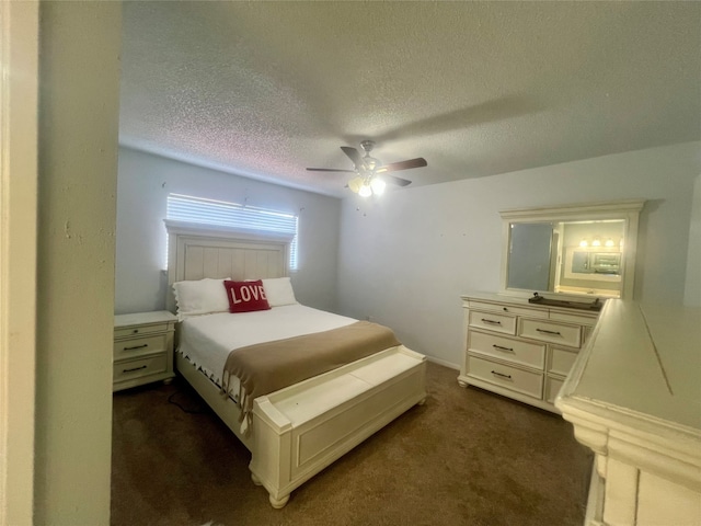 carpeted bedroom featuring ceiling fan and a textured ceiling