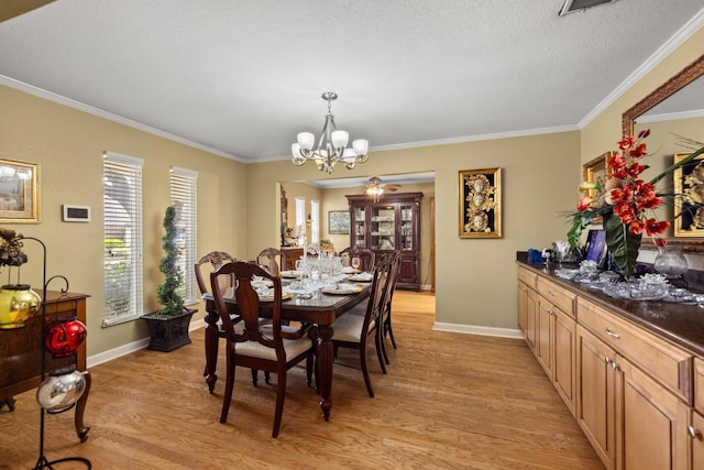 dining room featuring a notable chandelier, ornamental molding, light hardwood / wood-style floors, and a textured ceiling