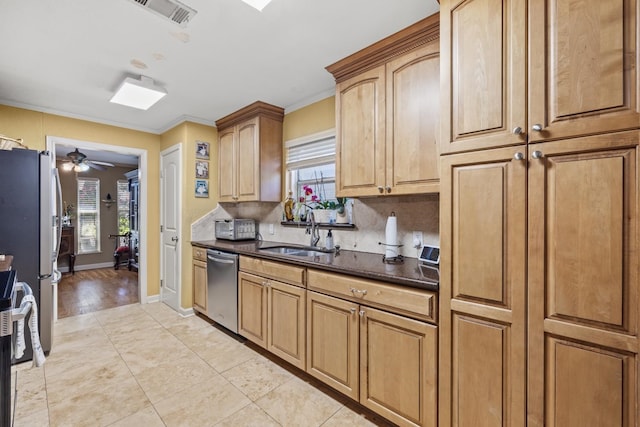 kitchen with light tile patterned flooring, backsplash, sink, ceiling fan, and stainless steel appliances