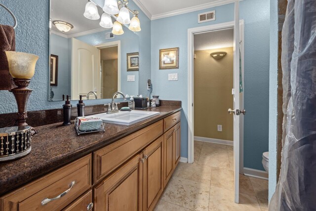 bathroom with toilet, tile patterned flooring, vanity, and ornamental molding