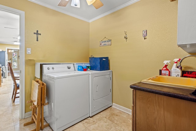 laundry area with washing machine and clothes dryer, sink, crown molding, light tile patterned floors, and ceiling fan