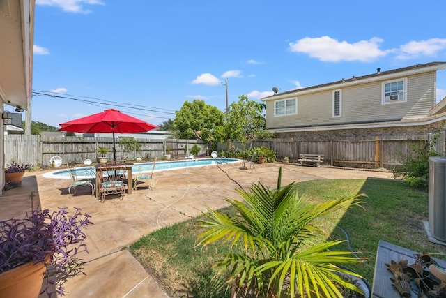 exterior space featuring a fenced in pool and a patio