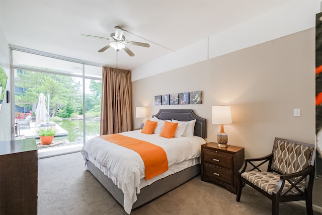 bedroom featuring light colored carpet, expansive windows, access to exterior, and ceiling fan