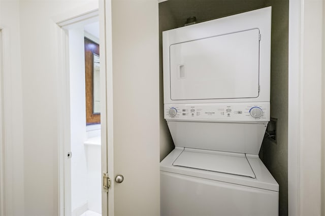 clothes washing area with stacked washer and dryer