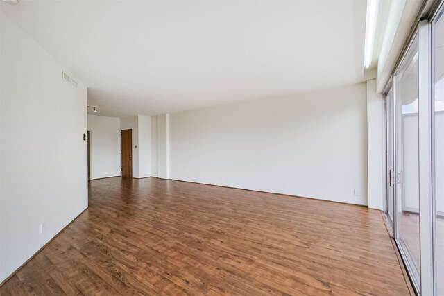 spare room featuring wood-type flooring