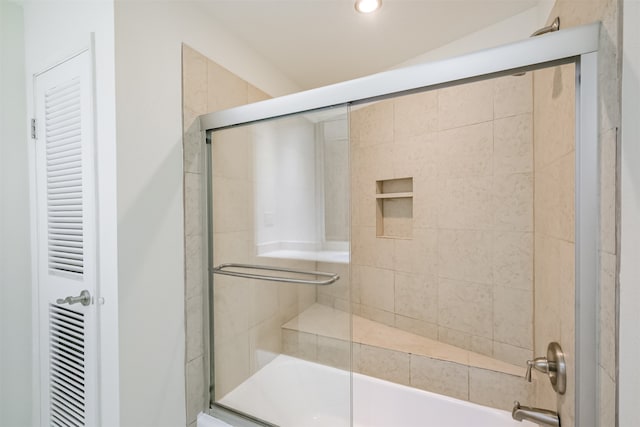 bathroom featuring shower / bath combination with glass door