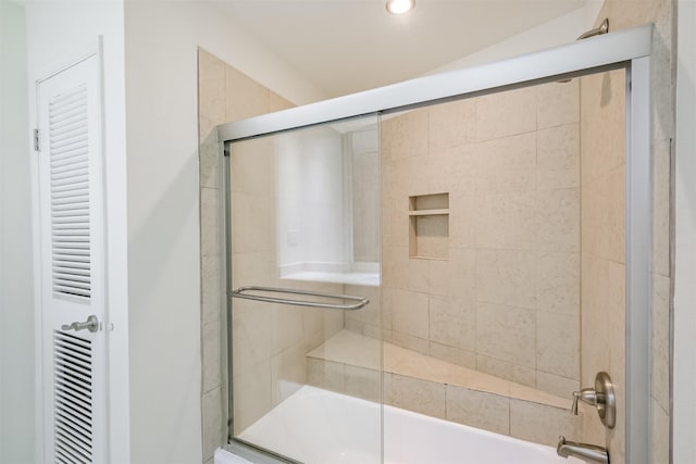 bathroom featuring combined bath / shower with glass door