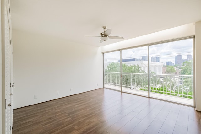 empty room featuring hardwood / wood-style flooring and ceiling fan