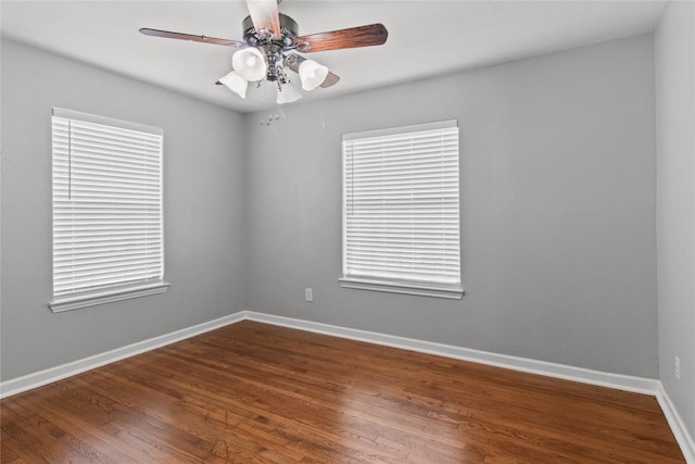 spare room with hardwood / wood-style flooring and ceiling fan