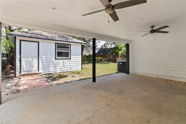 view of patio with an outdoor structure and ceiling fan