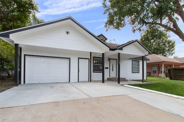 ranch-style home with a garage and a front lawn