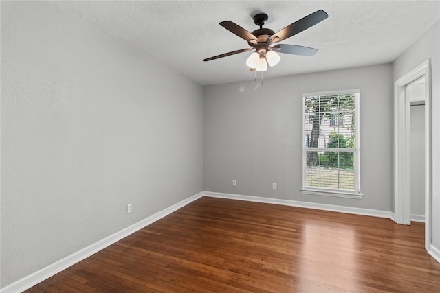 unfurnished bedroom featuring ceiling fan, dark hardwood / wood-style floors, and a textured ceiling