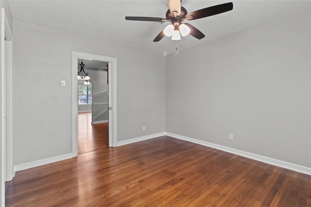 unfurnished room with dark hardwood / wood-style floors and ceiling fan