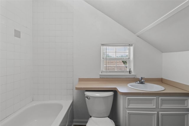 bathroom with vanity, lofted ceiling, and toilet