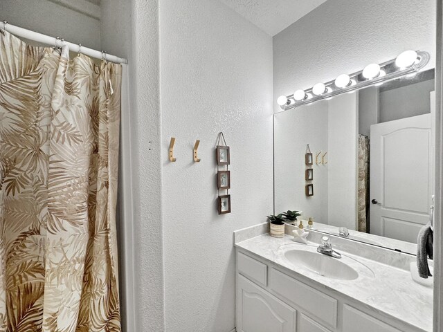 bathroom with a textured ceiling and vanity