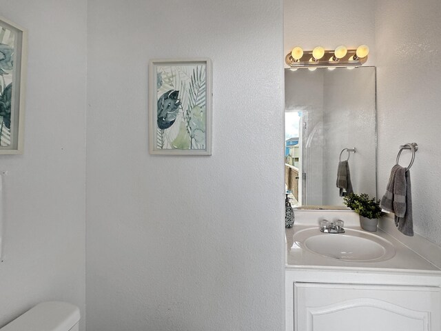 bathroom with toilet and vanity