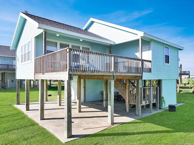 back of house featuring a patio, a carport, a lawn, and a shingled roof