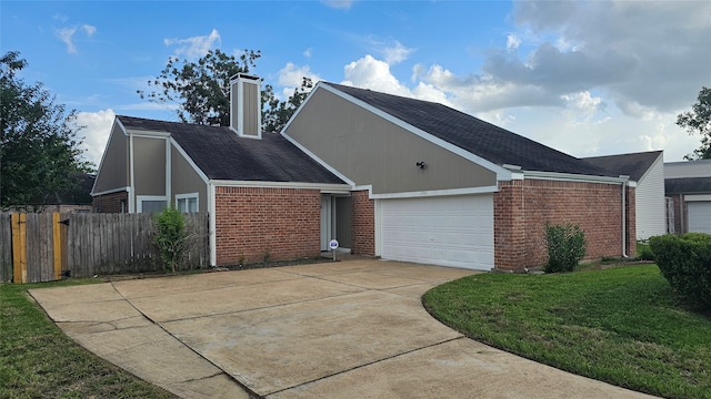 view of front of home with a garage and a front lawn