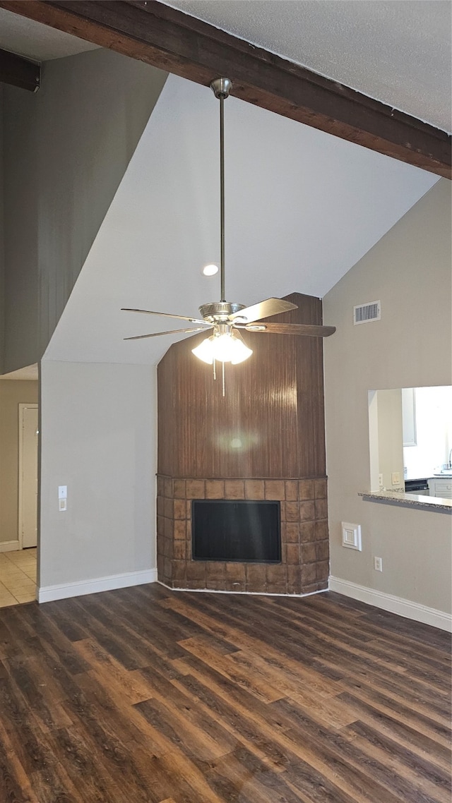 unfurnished living room featuring hardwood / wood-style floors, a large fireplace, high vaulted ceiling, and ceiling fan