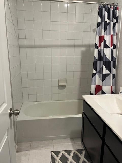 bathroom with tile patterned flooring, vanity, and shower / tub combo with curtain