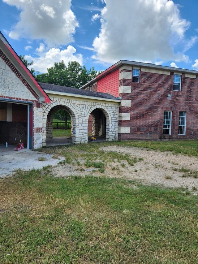 view of side of property with a garage and a yard