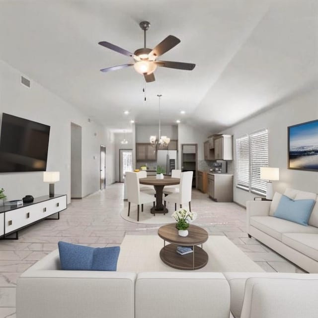 living room with vaulted ceiling and ceiling fan with notable chandelier