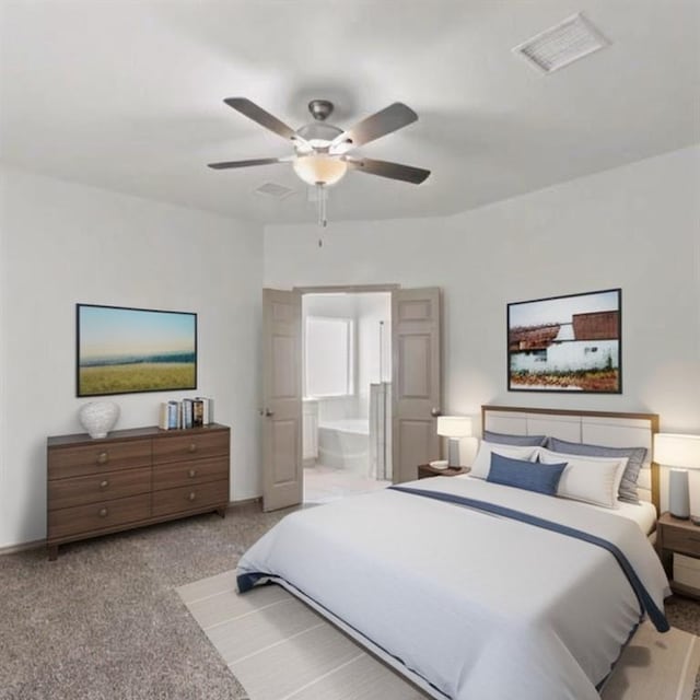 bedroom with connected bathroom, light colored carpet, and ceiling fan