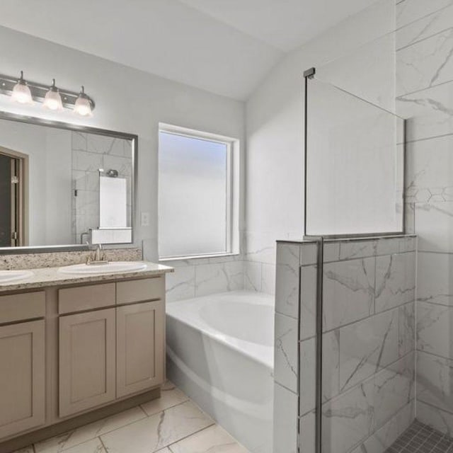 bathroom featuring vanity, vaulted ceiling, and shower with separate bathtub