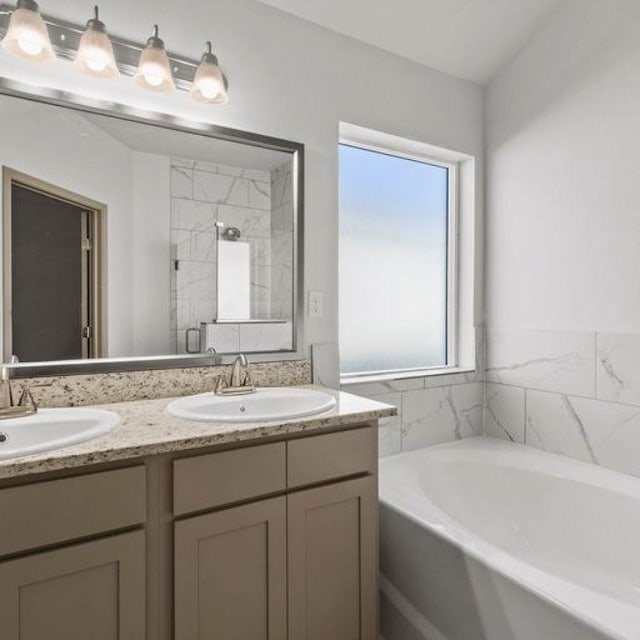 bathroom featuring vanity and plus walk in shower