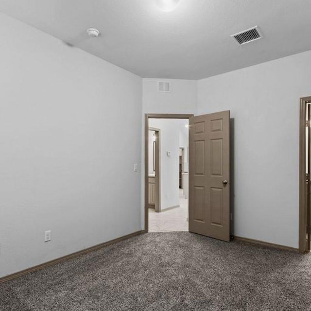 empty room featuring light colored carpet