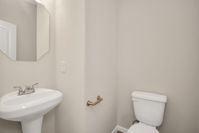 bathroom with toilet and a sink