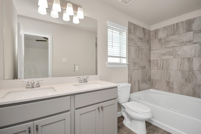 full bath featuring shower / tub combination, a sink, toilet, and double vanity