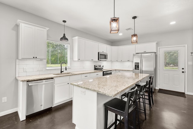 kitchen with backsplash, stainless steel appliances, and a center island