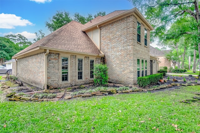 rear view of property featuring a lawn