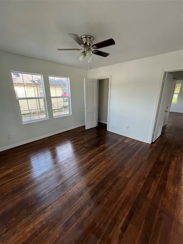 unfurnished room with ceiling fan, plenty of natural light, and dark hardwood / wood-style floors