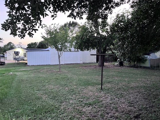 view of yard at dusk