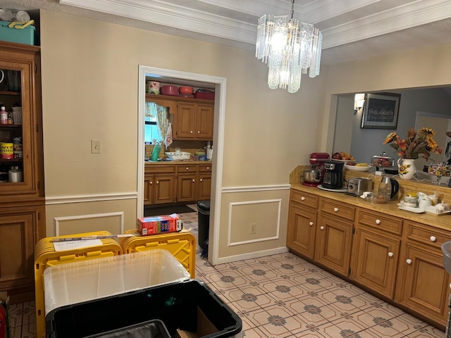 kitchen featuring crown molding, a chandelier, light tile patterned floors, and hanging light fixtures