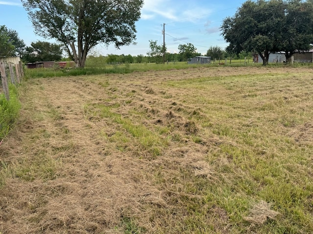 view of yard with a rural view