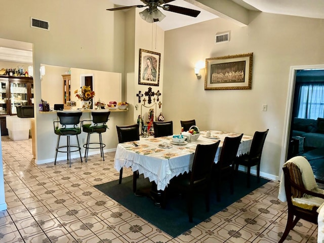 dining area with ceiling fan, vaulted ceiling with beams, and light tile patterned flooring