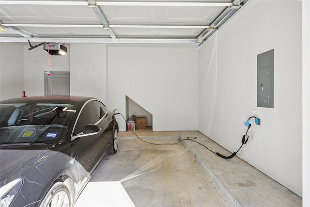 garage with a garage door opener and electric panel