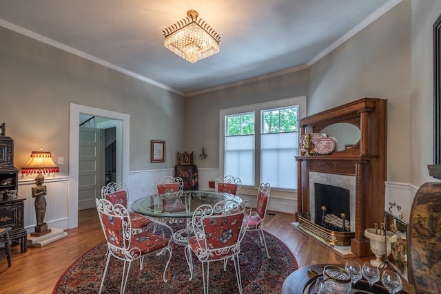 dining space featuring hardwood / wood-style floors and ornamental molding